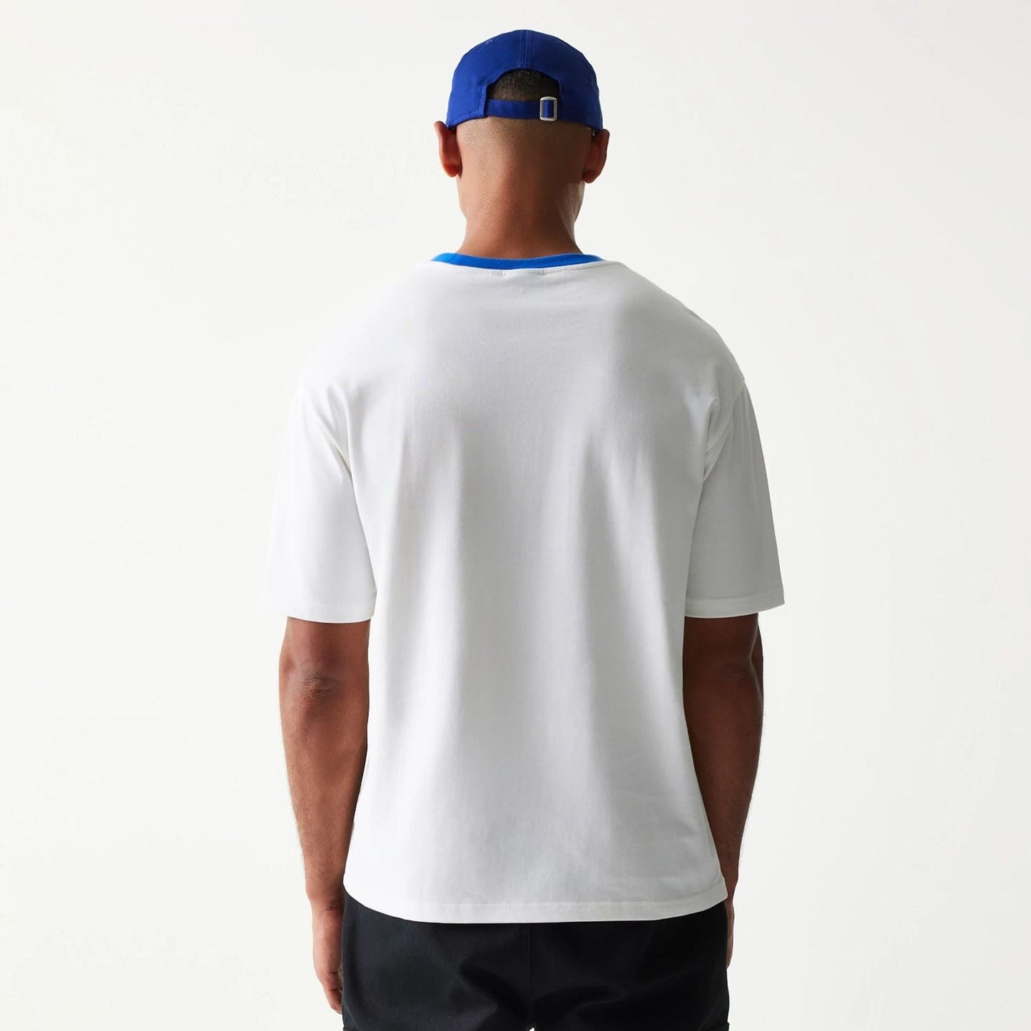 The model is wearing this New Era Script Oversized T-Shirt in white. 2