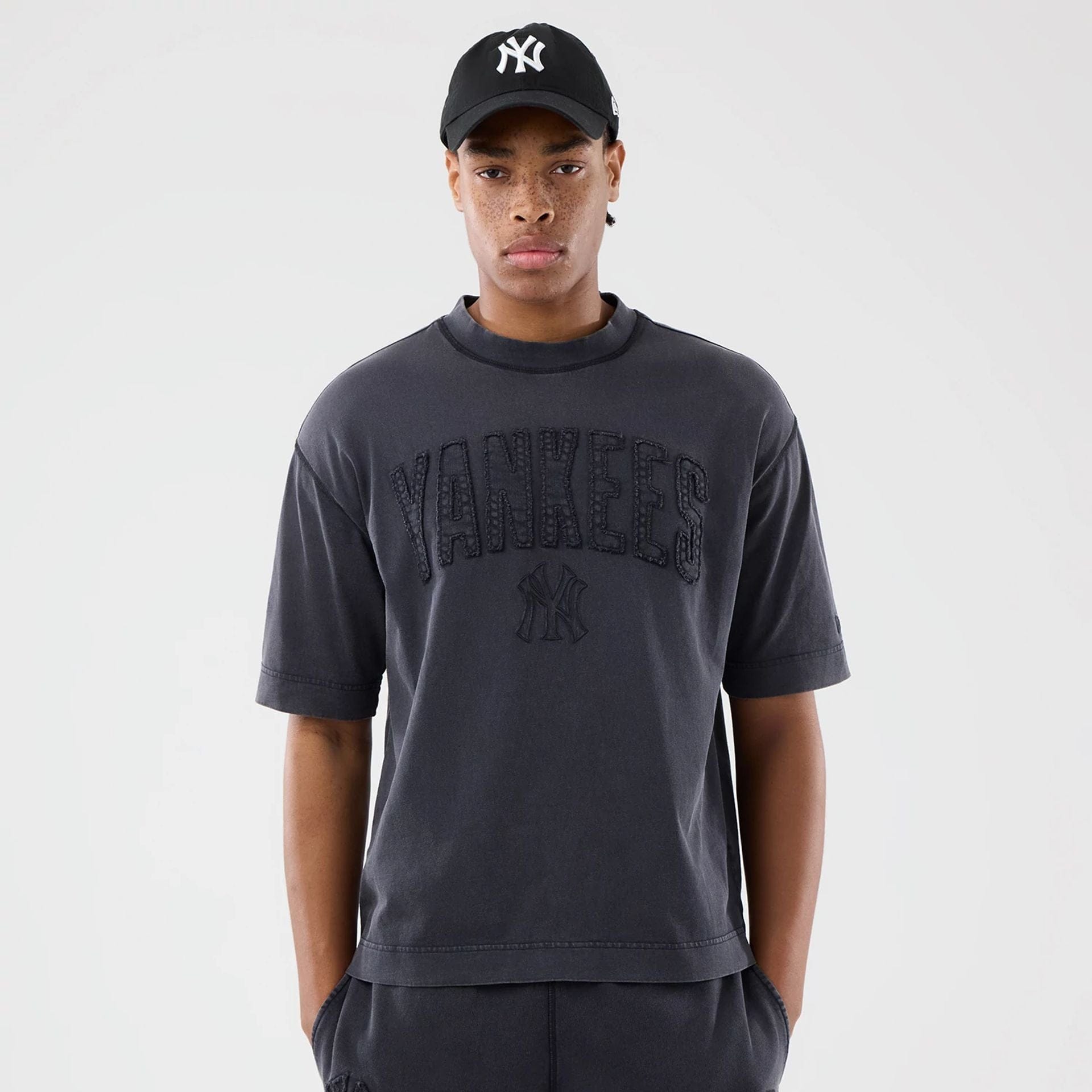 The model is wearing this MLB Washed New York Yankees T-Shirt in black. 1