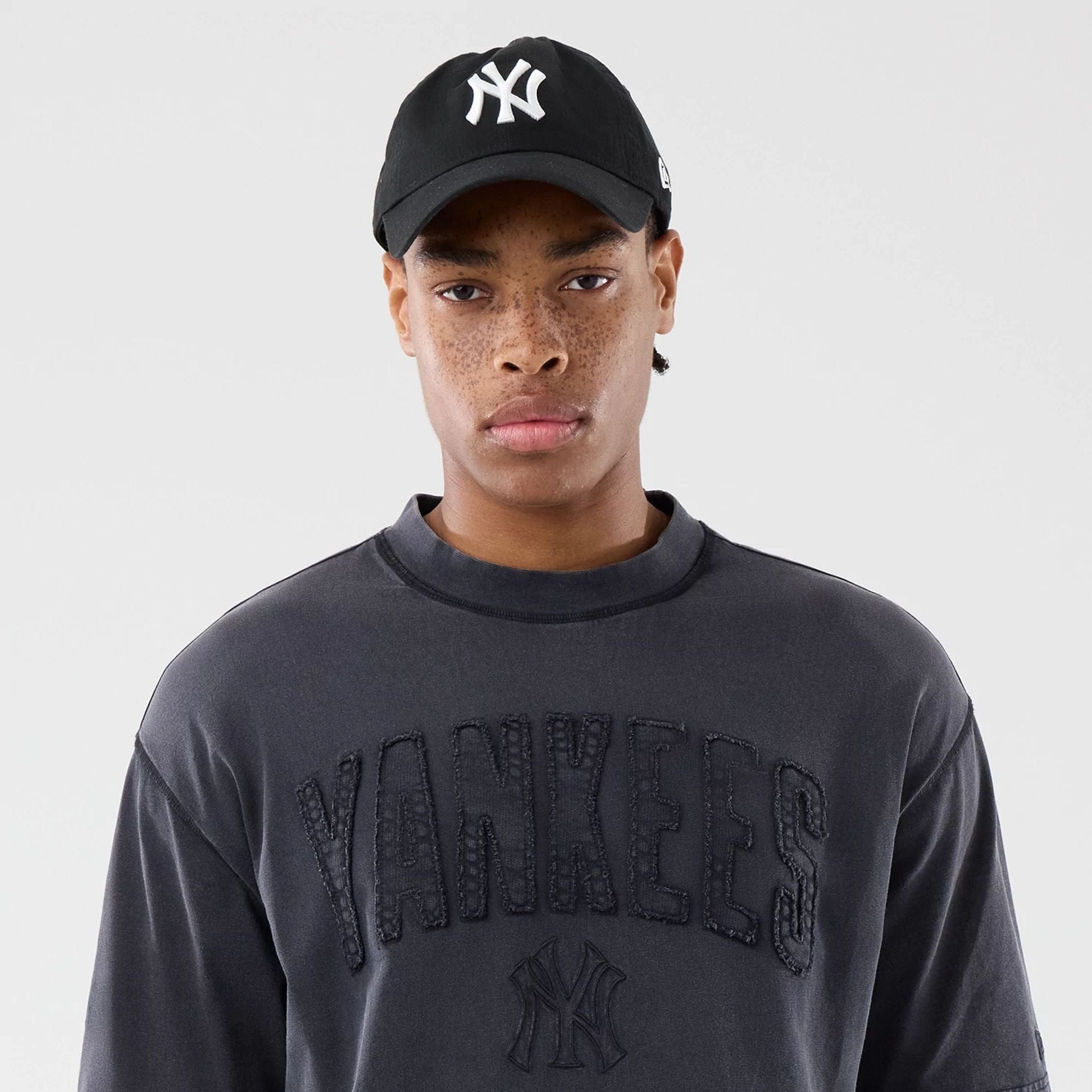 The model is wearing this MLB Washed New York Yankees T-Shirt in black. 6
