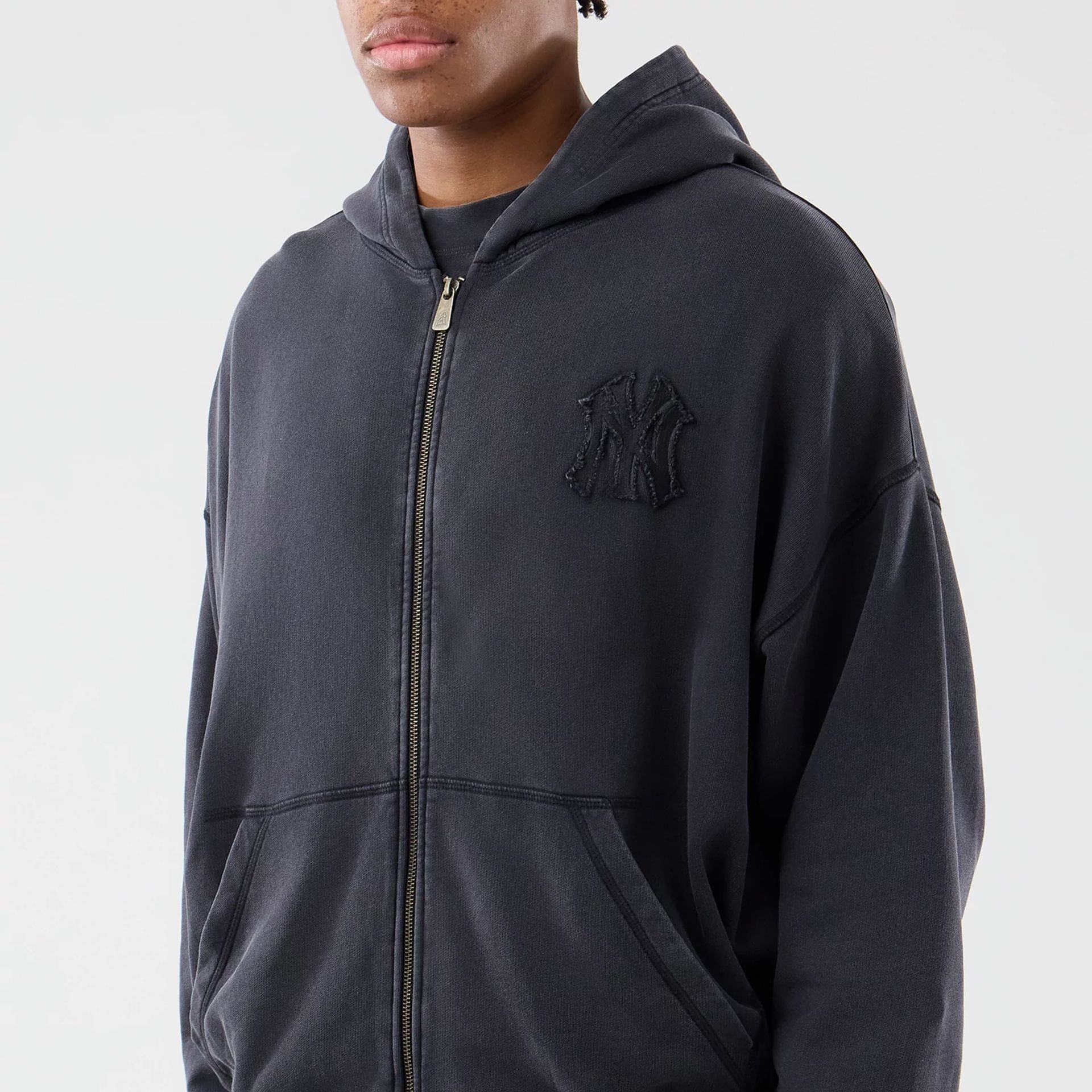 The model is wearing this MLB Washed New York Yankees Full Zip Hoodie in black. 3
