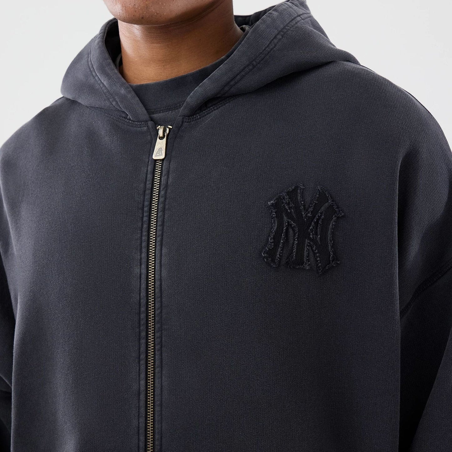 The model is wearing this MLB Washed New York Yankees Full Zip Hoodie in black. 4