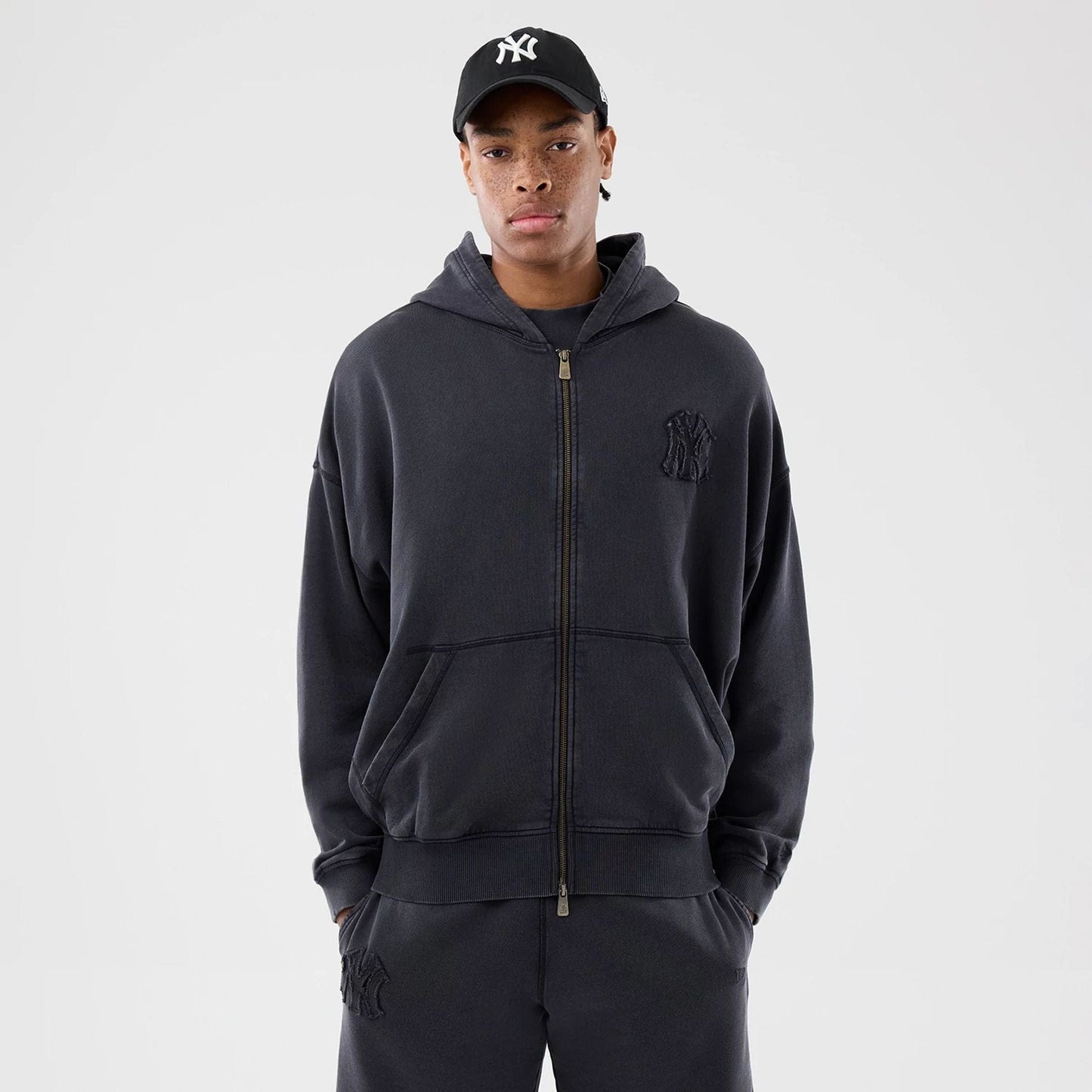 The model is wearing this MLB Washed New York Yankees Full Zip Hoodie in black. 1