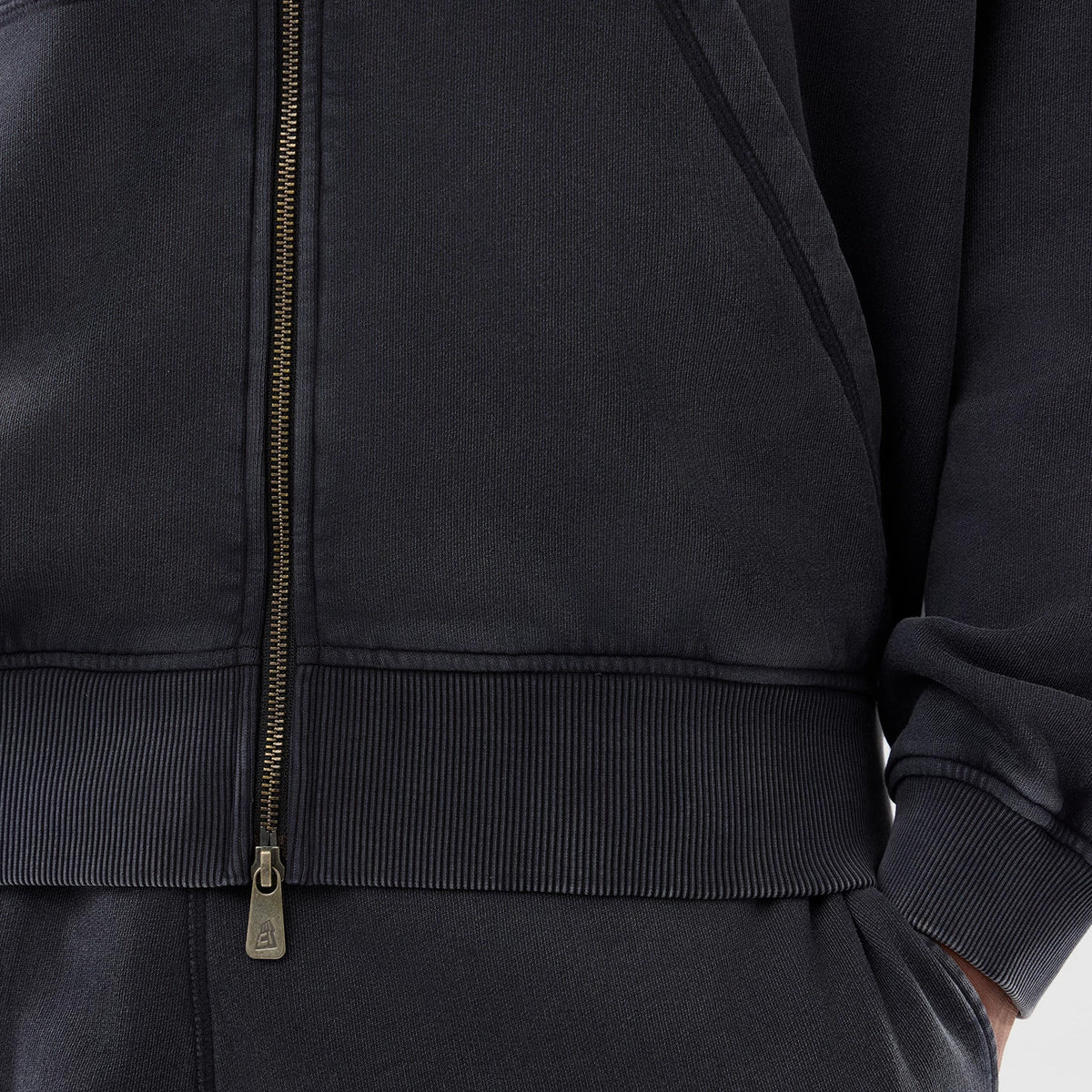 New Era New York Yankees MLB Washed Black Full Zip Hoodie, front view showing the centralised zip closure, ribbed hem, and cuff detail with stitching running across the waistband and pockets.