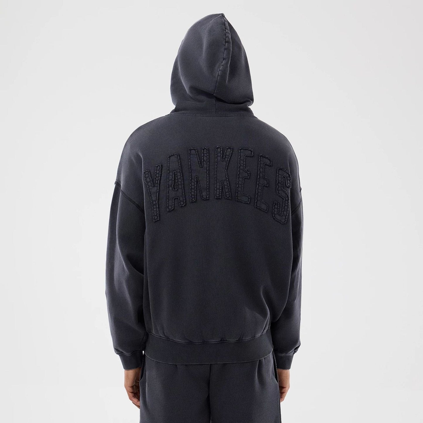 The model is wearing this MLB Washed New York Yankees Full Zip Hoodie in black. 2