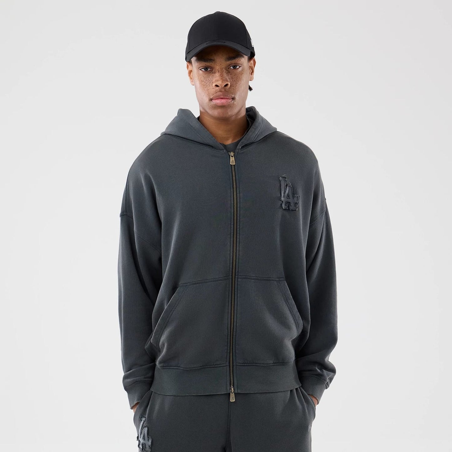 The model is wearing this MLB Washed LA Dodgers Full Zip Hoodie in Dark Grey. 1