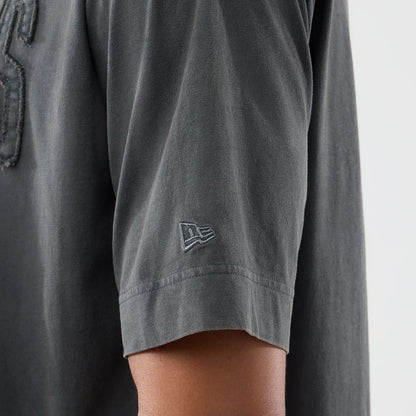 New Era LA Dodgers MLB Washed Dark Grey T-Shirt, close-up view of the sleeve showing the embroidered New Era logo in matching dark grey near the hem, with part of a textured graphic just around the shoulder area.