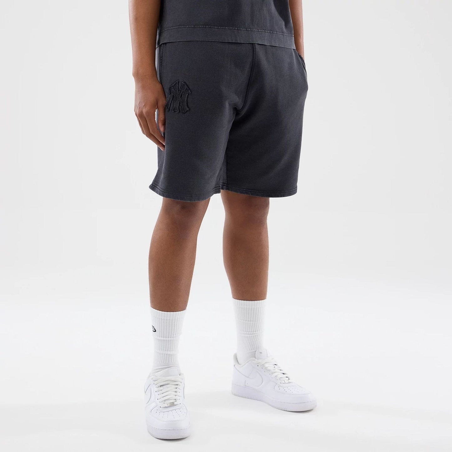 The model is wearing this MLB Washed New York Yankees Shorts in black. 1