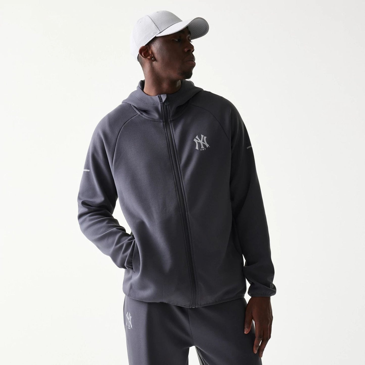 The model is wearing this MLB New York Yankees Full Zip Hoodie in dark grey. 1
