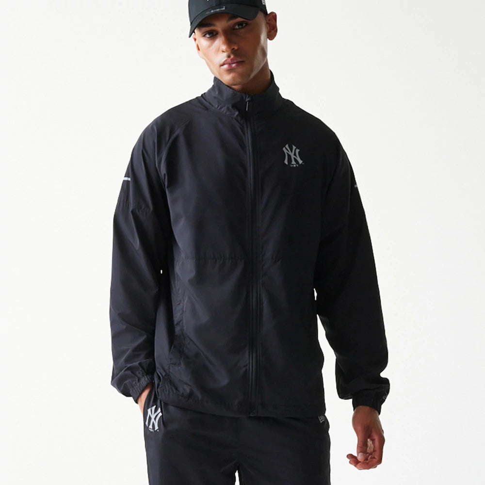 The model is wearing this MLB Reflective Strip New York Yankees Jacket in black. 4