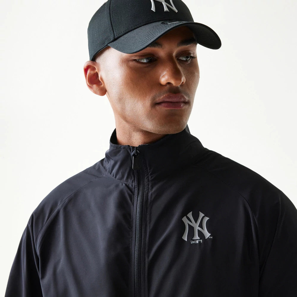 The model is wearing this MLB Reflective Strip New York Yankees Jacket in black. 3