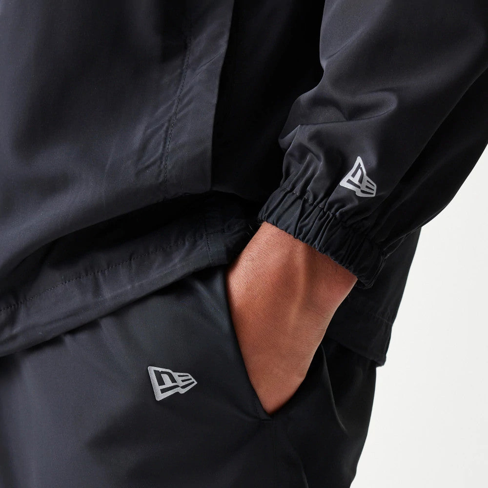 The model is wearing this MLB Reflective Logo New York Yankees Track Pants in black. 4