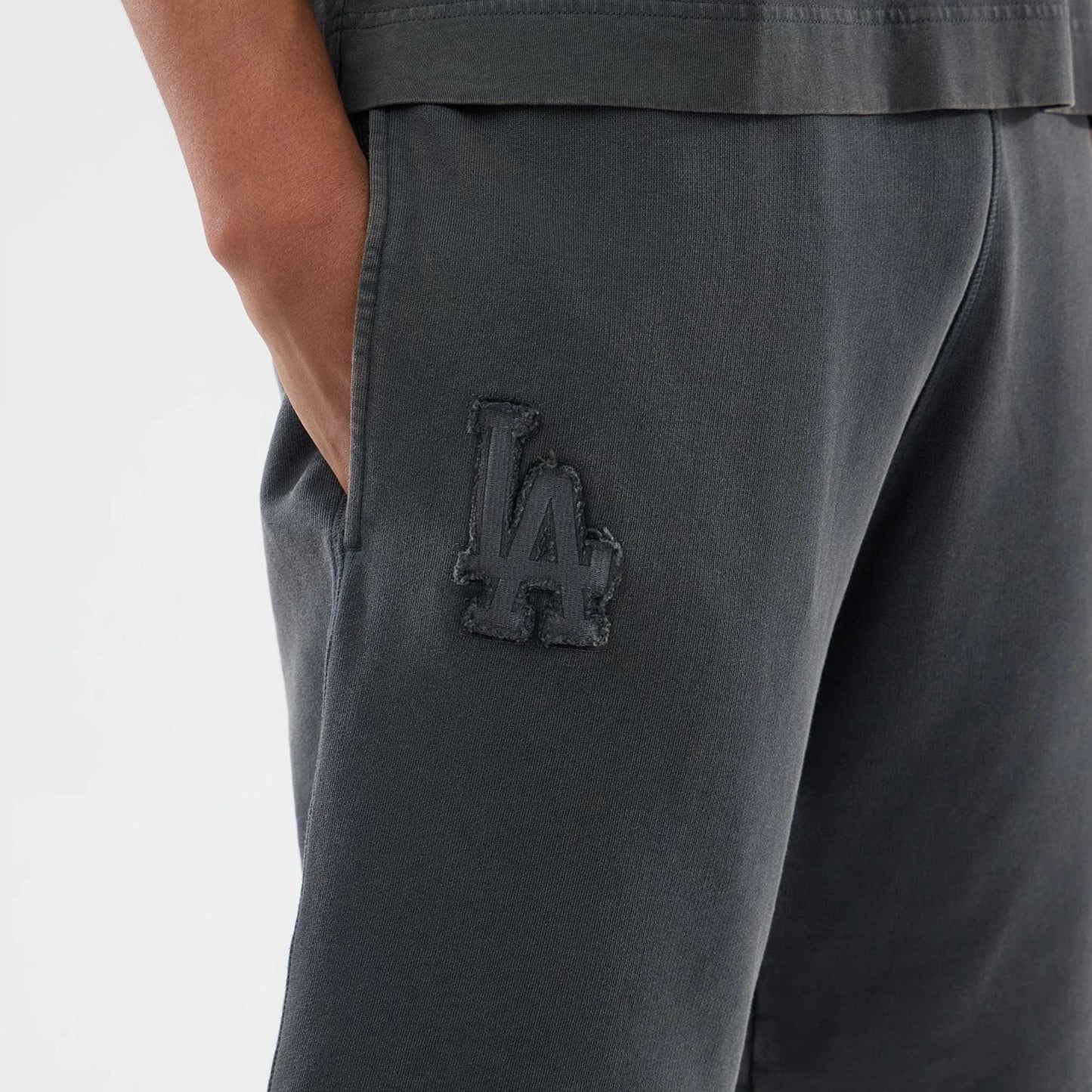 The model is wearing this MLB Washed LA Dodgers Shorts in Dark Grey. 3
