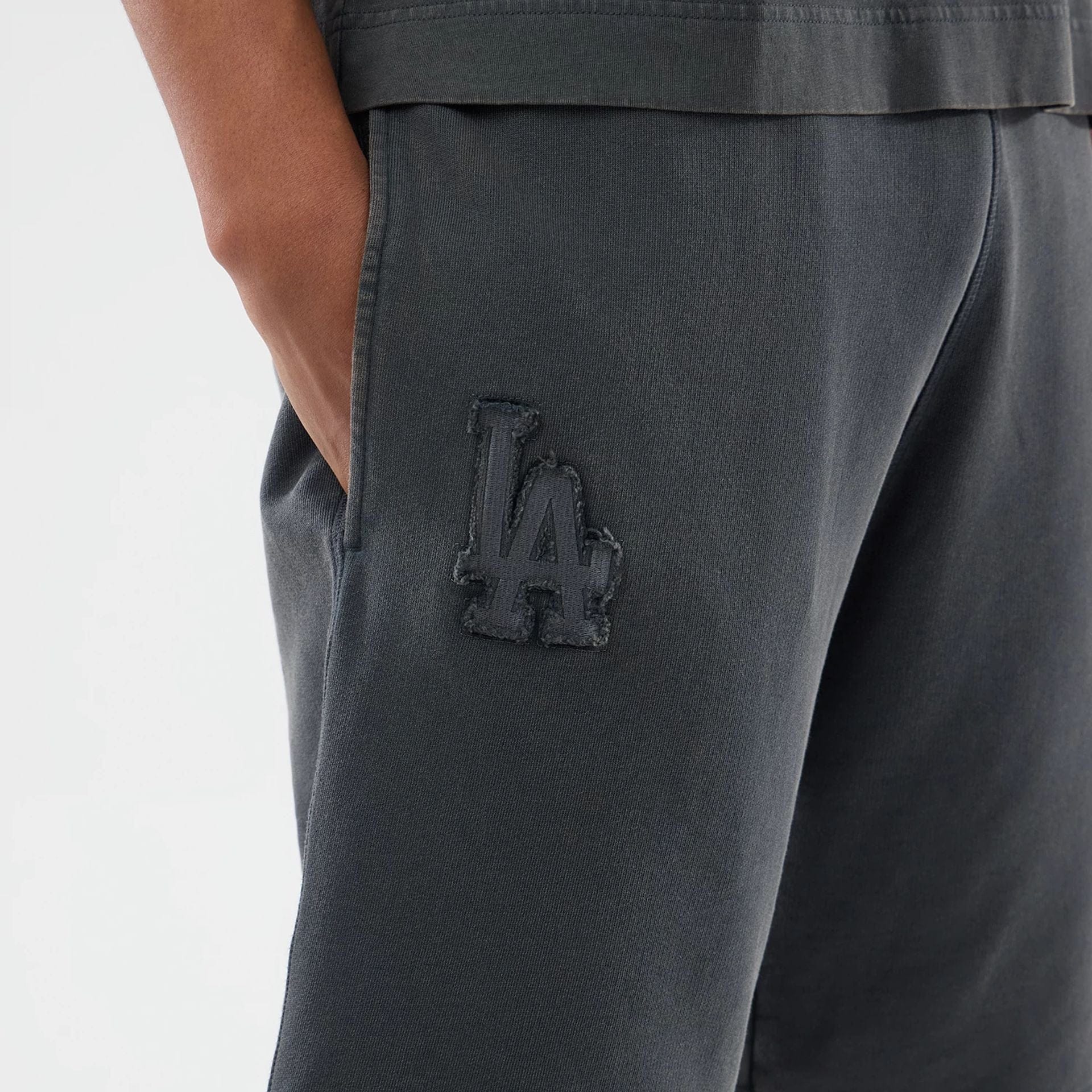 The model is wearing this MLB Washed LA Dodgers Shorts in Dark Grey. 3