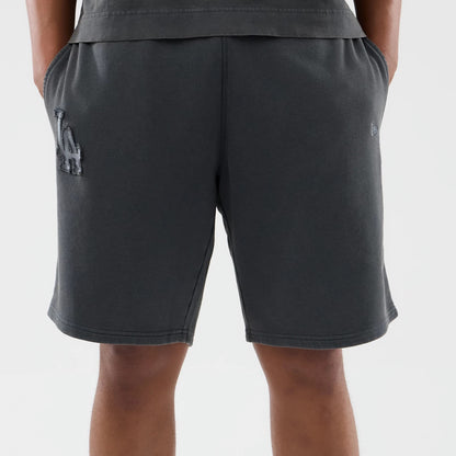 New Era LA Dodgers MLB Washed Dark Grey Shorts, back view showing the dark grey fabric with a raised LA Dodgers logo on the left leg, an embroidered New Era logo on the right leg, and side pockets.