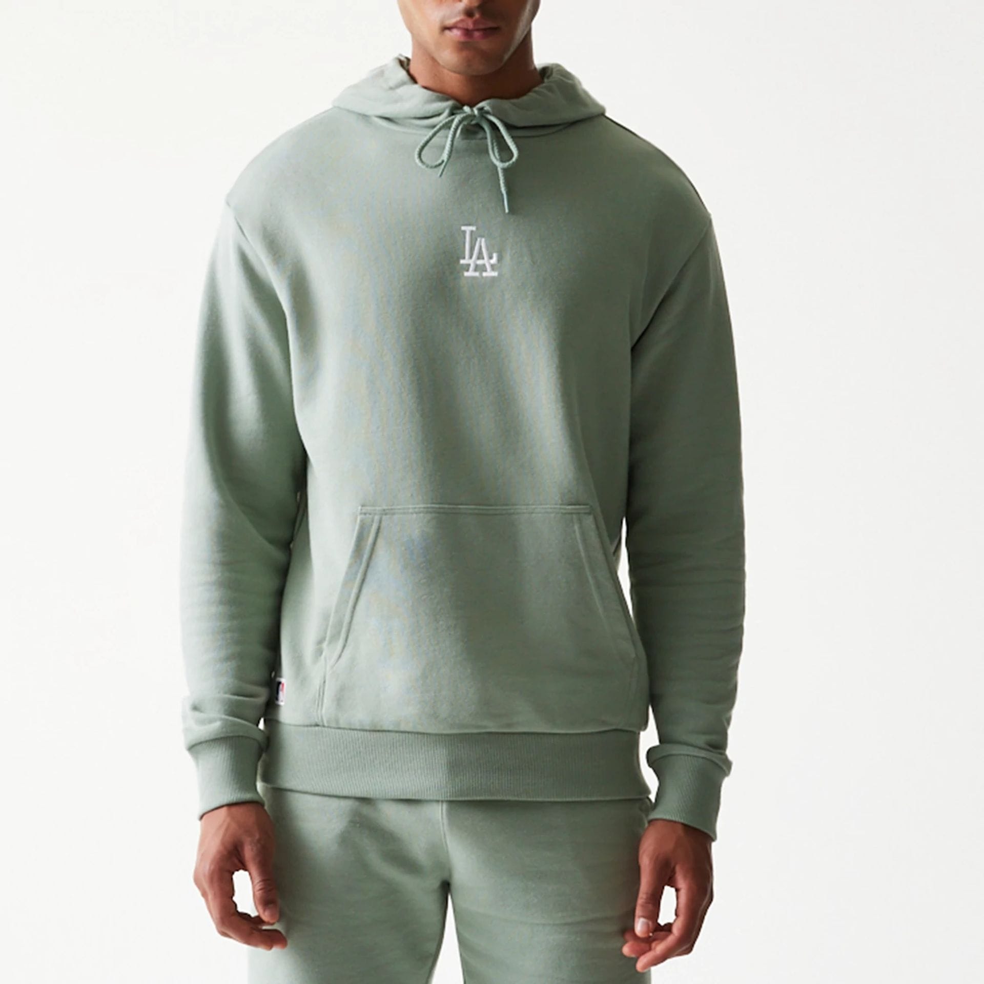 The model is wearing this MLB League Essential Midi LA Dodgers Oversized Pullover Hoodie in pastel green. 3