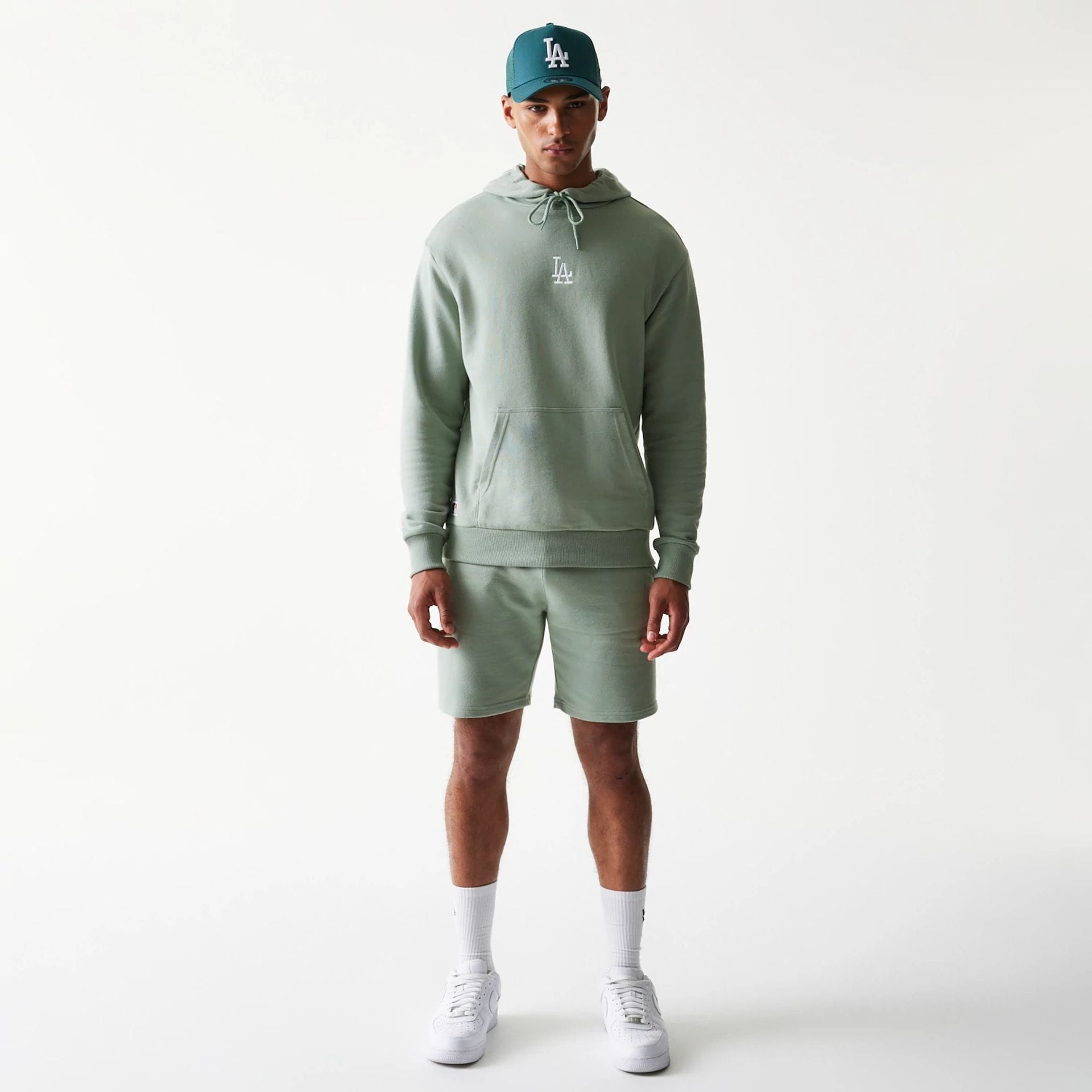 The model is wearing this MLB League Essential Midi LA Dodgers Oversized Pullover Hoodie in pastel green. 8