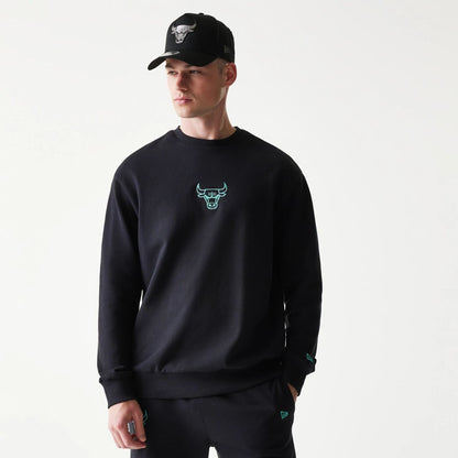 The model is wearing this NBA League Essential Chicago Bulls Oversized Crew Neck Sweater in black. 1