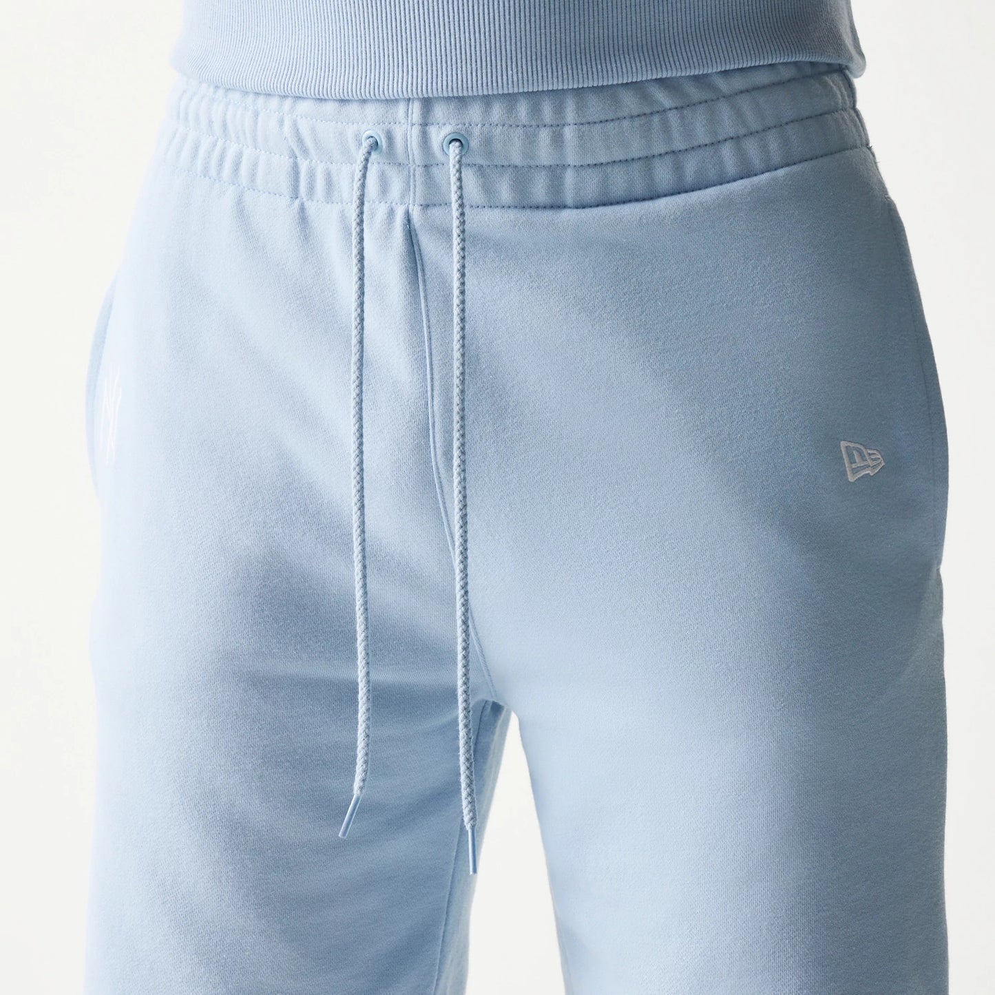 The model is wearing this MLB League Essential Midi New York Yankees Shorts in blue. 6