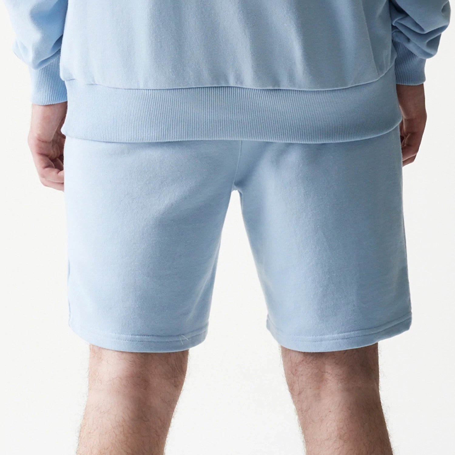 The model is wearing this MLB League Essential Midi New York Yankees Shorts in blue. 7