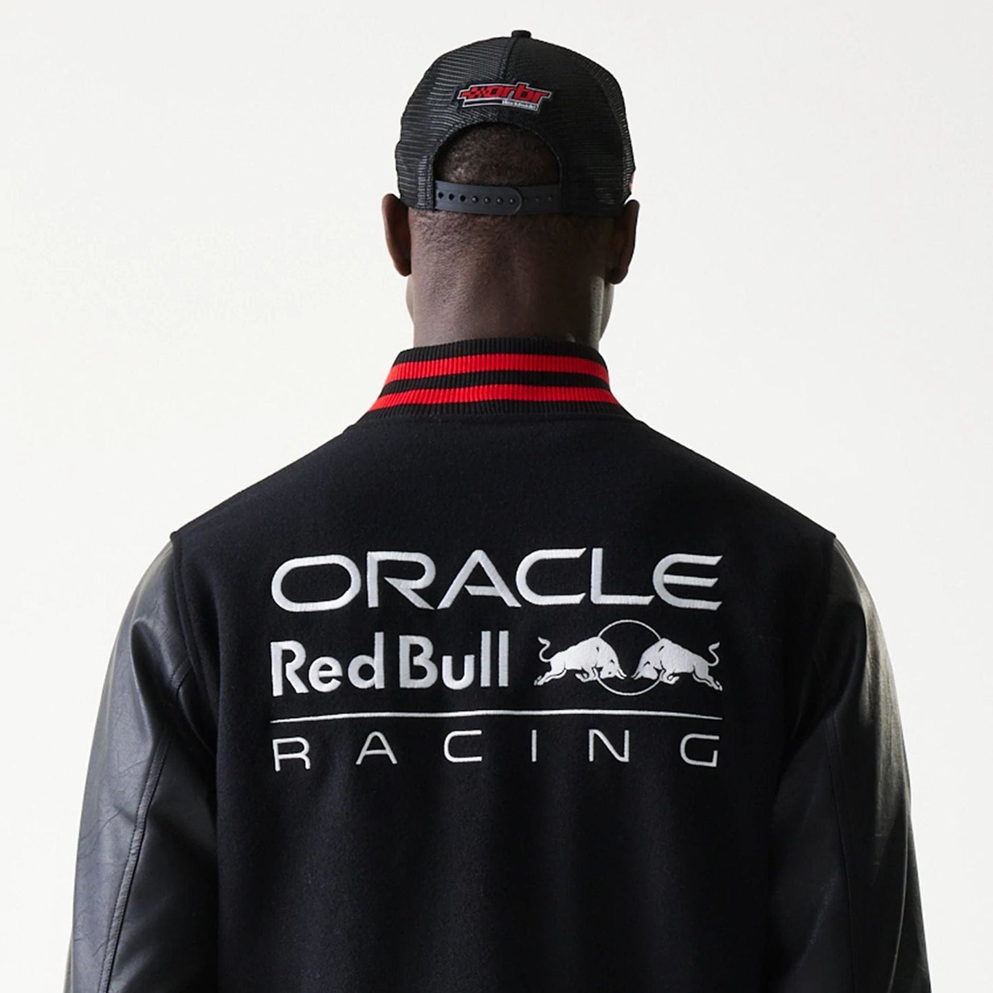 The model is wearing this Red Bull Racing Varsity Jacket in black. 7