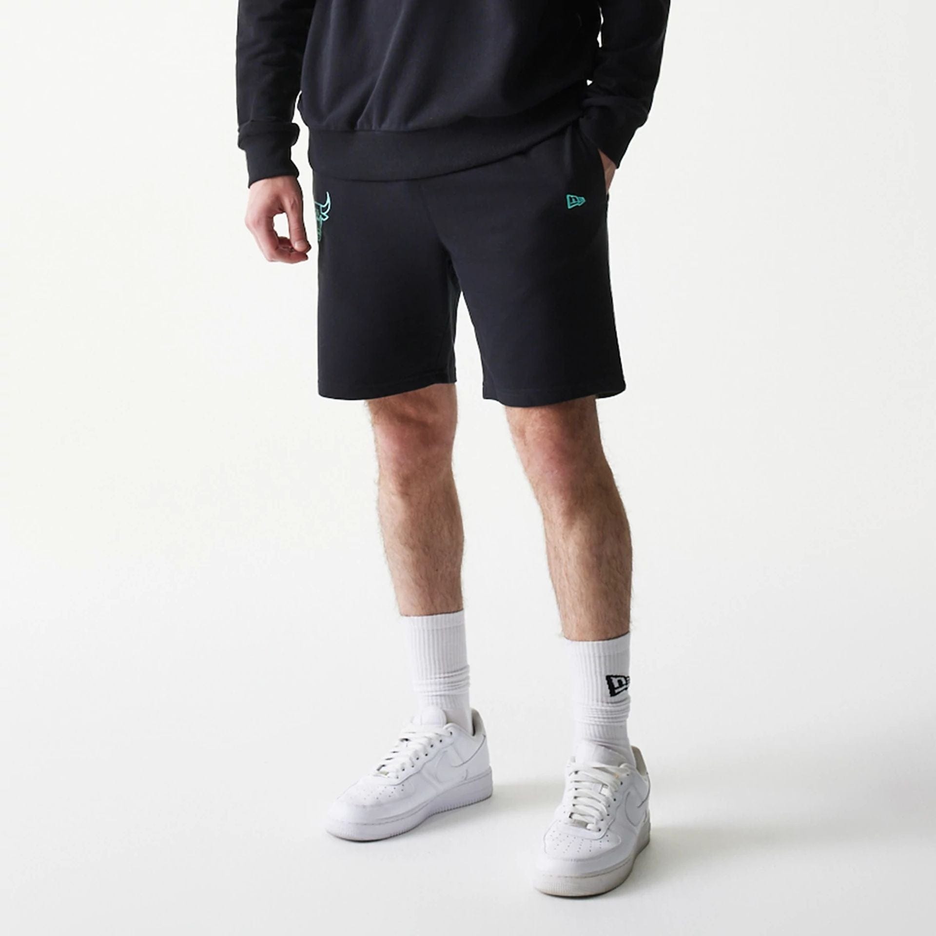 The model is wearing this NBA League Essential Chicago Bulls Shorts in black. 7