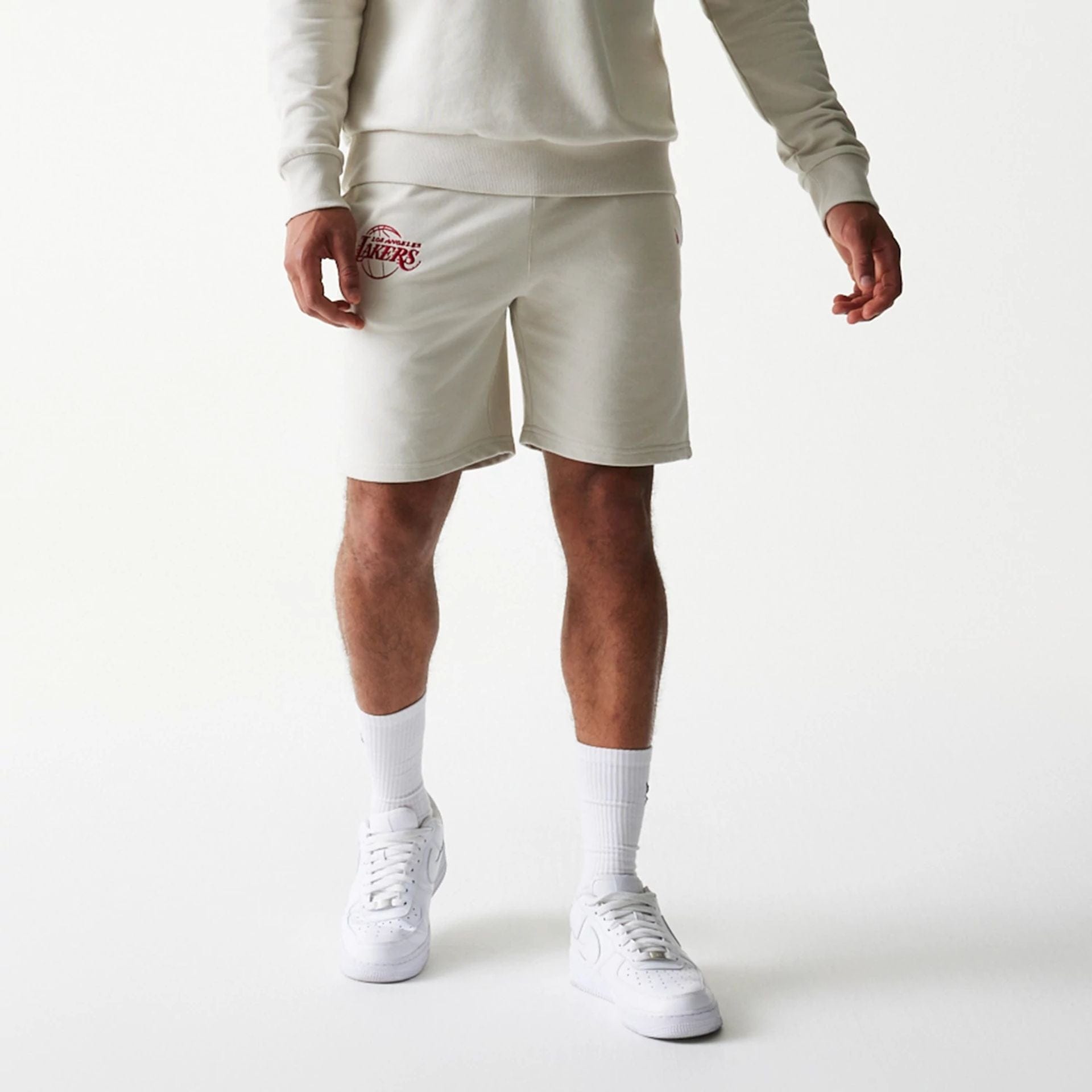 The model is wearing this NBA League Essential LA Lakers Shorts in light beige. 7