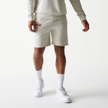 The model is wearing this NBA League Essential LA Lakers Shorts in light beige. 7