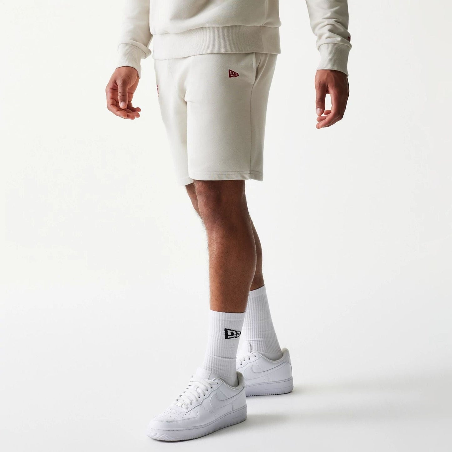 The model is wearing this NBA League Essential LA Lakers Shorts in light beige. 1