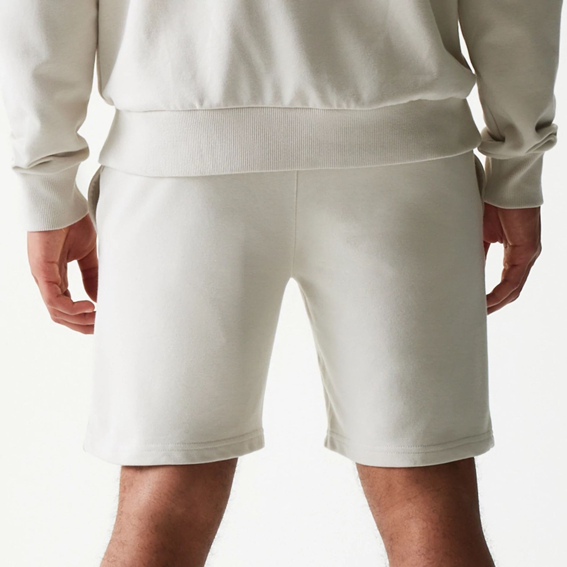 The model is wearing this NBA League Essential LA Lakers Shorts in light beige. 6