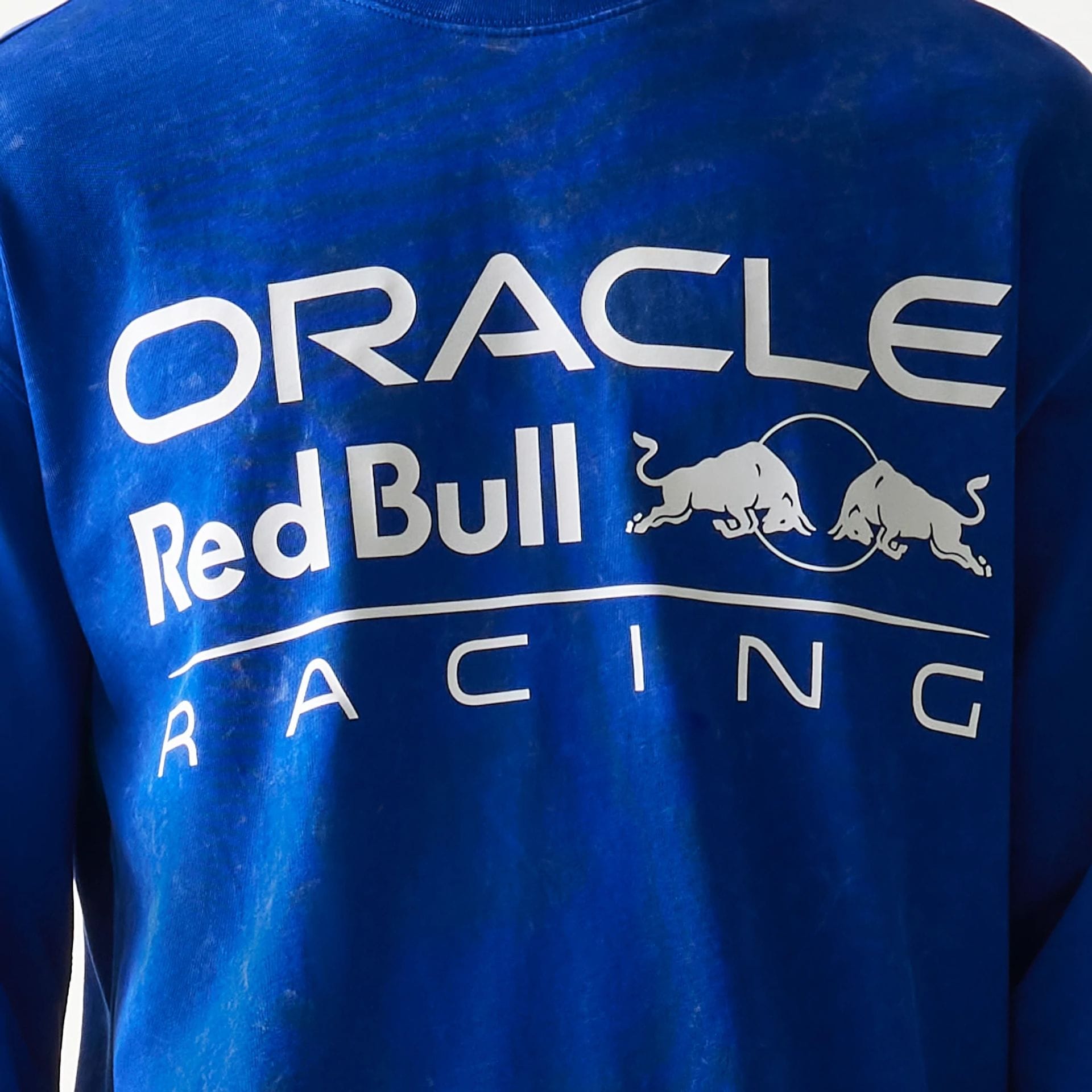 The model is wearing this Red Bull Racing Linear Graphic Long Sleeve T-Shirt in blue. 6
