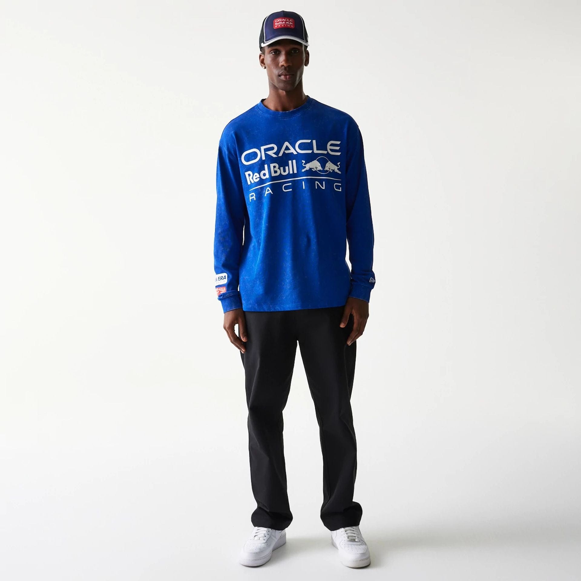 The model is wearing this Red Bull Racing Linear Graphic Long Sleeve T-Shirt in blue. 8