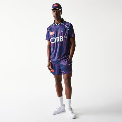 New Era Red Bull Racing All Over Print Dark Blue Football T-Shirt, on-model view showing the print with large ORBR lettering on the front, embroidered New Era logo on the chest, and matching cap and shorts for a coordinated look.