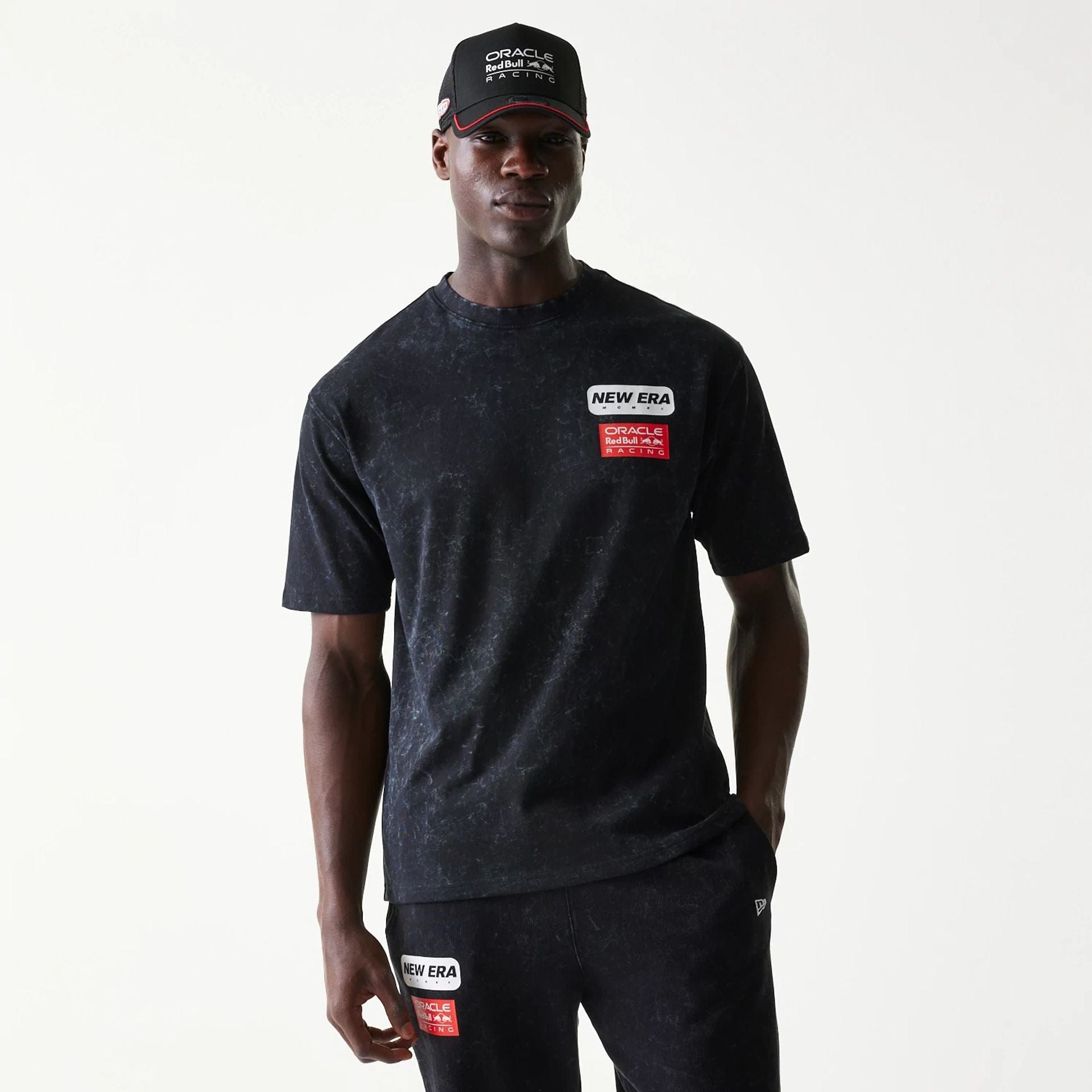 The model is wearing this Red Bull Racing Linear Graphic Oversized T-Shirt in black. 1
