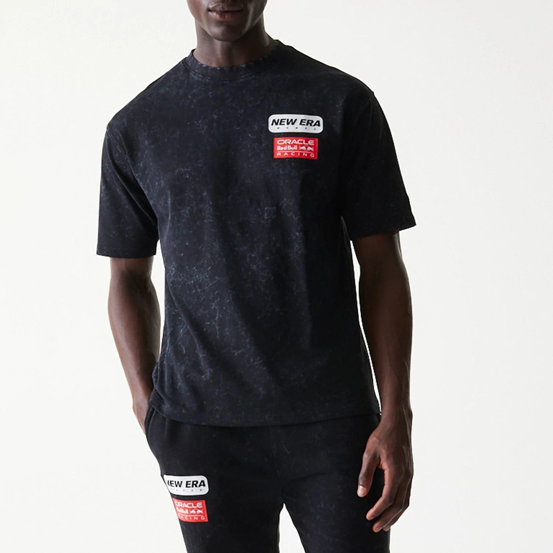 The model is wearing this Red Bull Racing Linear Graphic Oversized T-Shirt in black. 3