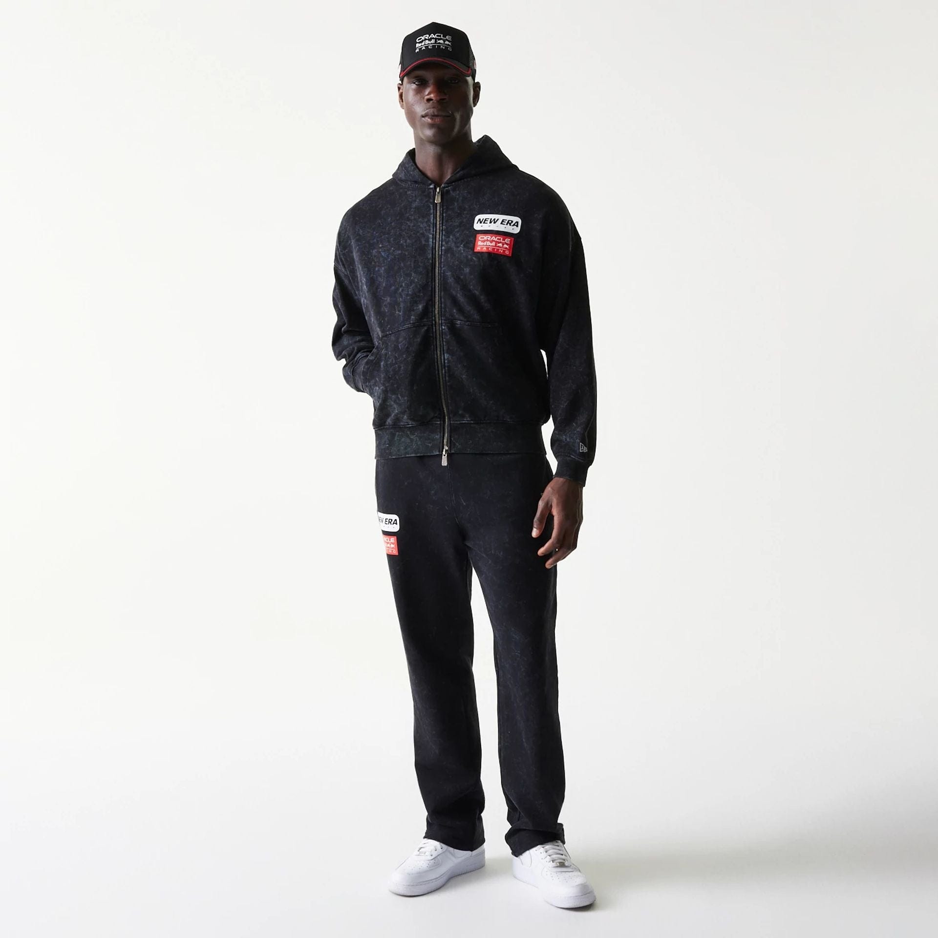 The model is wearing this Red Bull Racing Dropped Shoulder Full Zip Hoodie in black. 8