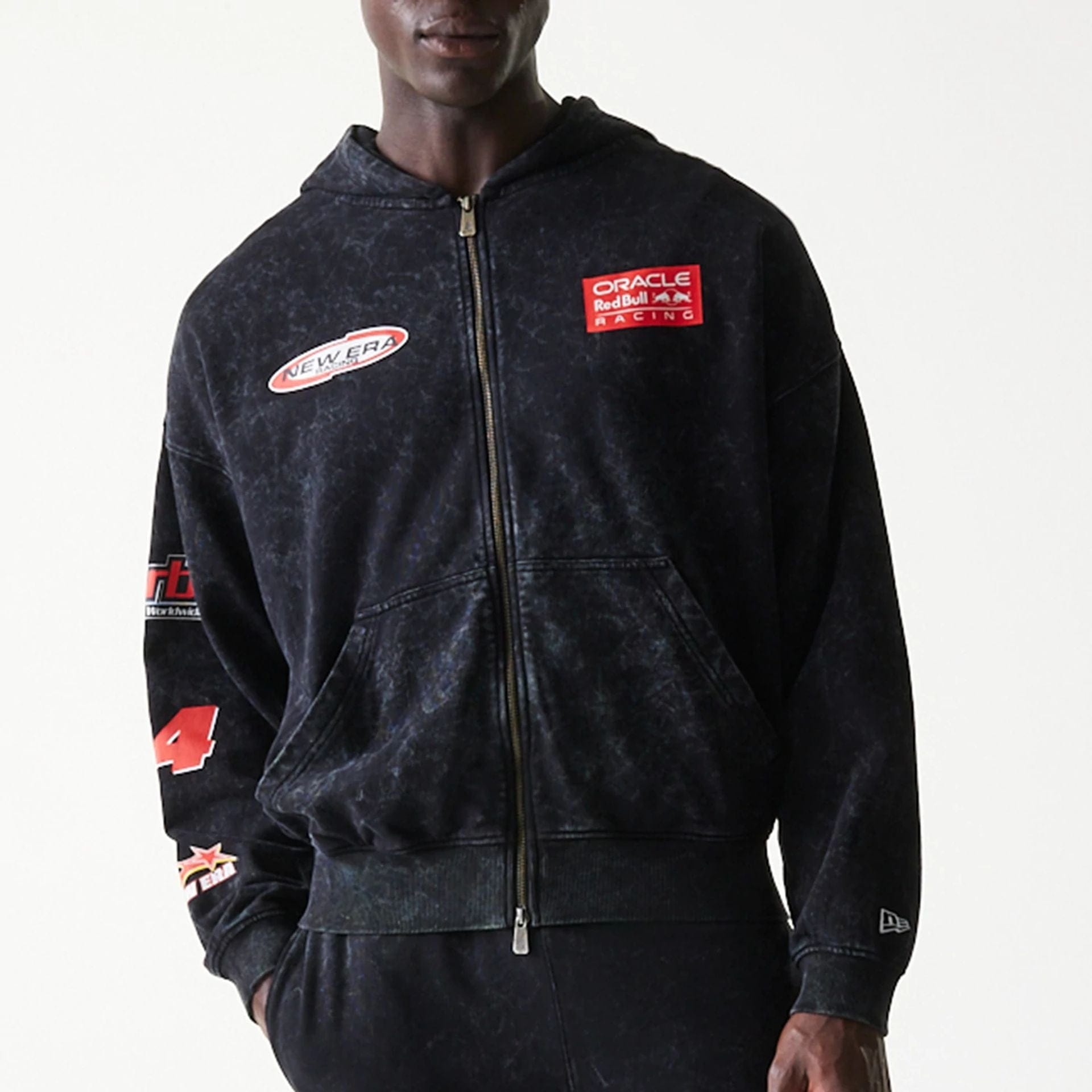 The model is wearing this Red Bull Racing Graphic Dropped Shoulder Full Zip Hoodie in black. 6