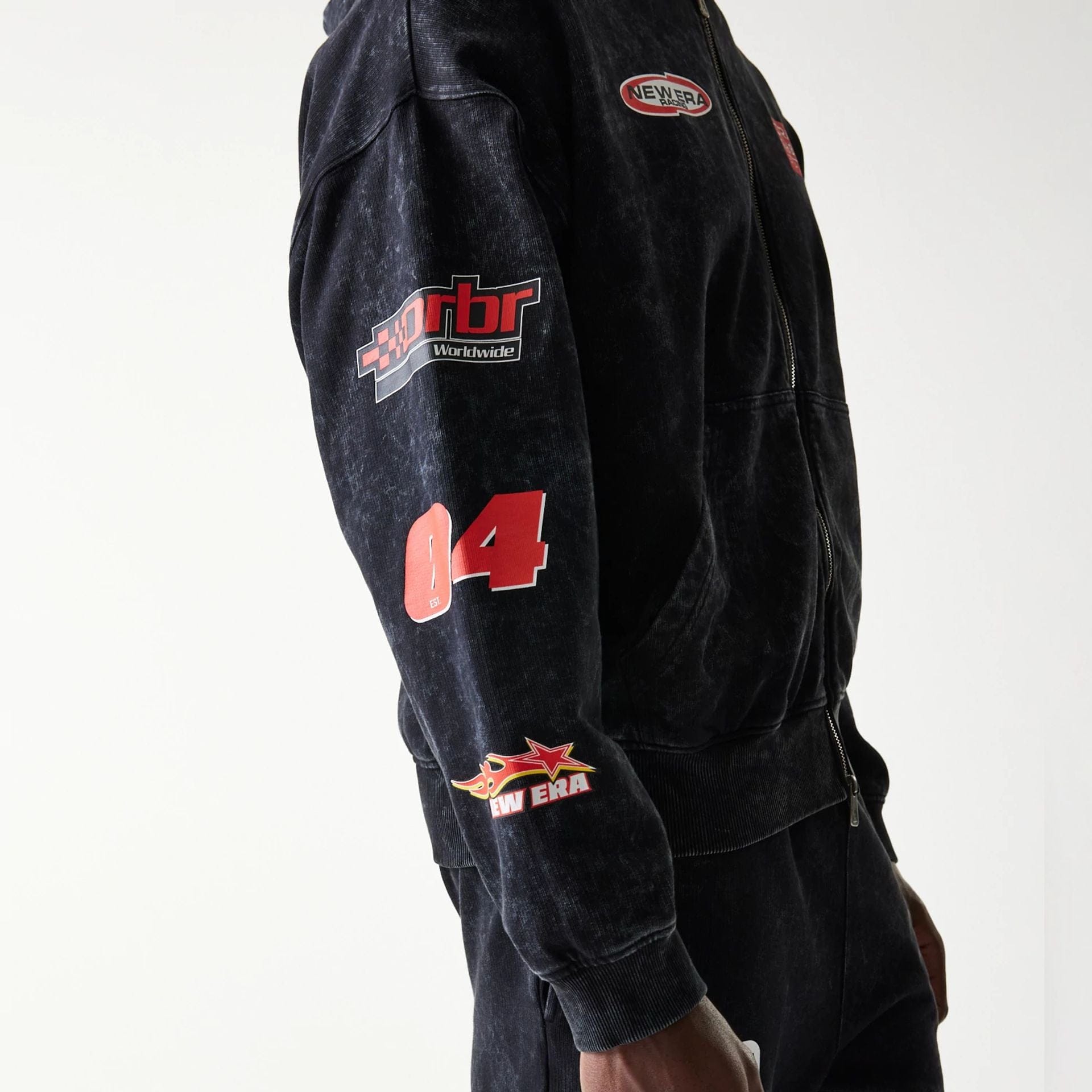 The model is wearing this Red Bull Racing Graphic Dropped Shoulder Full Zip Hoodie in black. 3