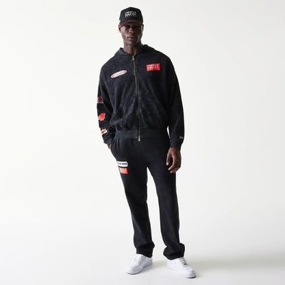 The model is wearing this Red Bull Racing Graphic Dropped Shoulder Full Zip Hoodie in black. 5