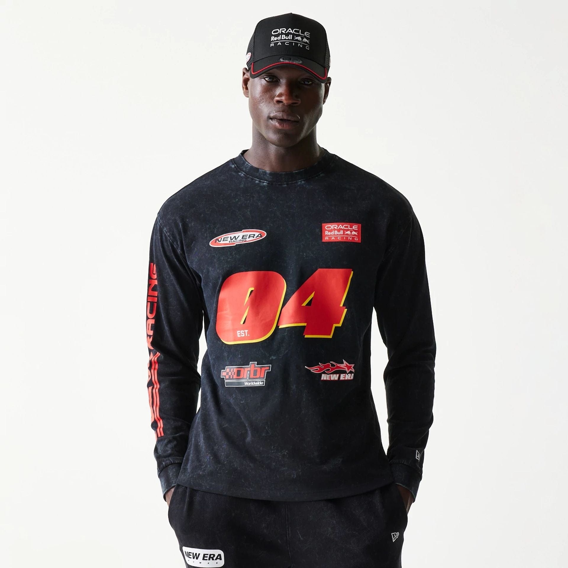 The model is wearing this Red Bull Racing Graphic Long Sleeve T-Shirt in black. 1