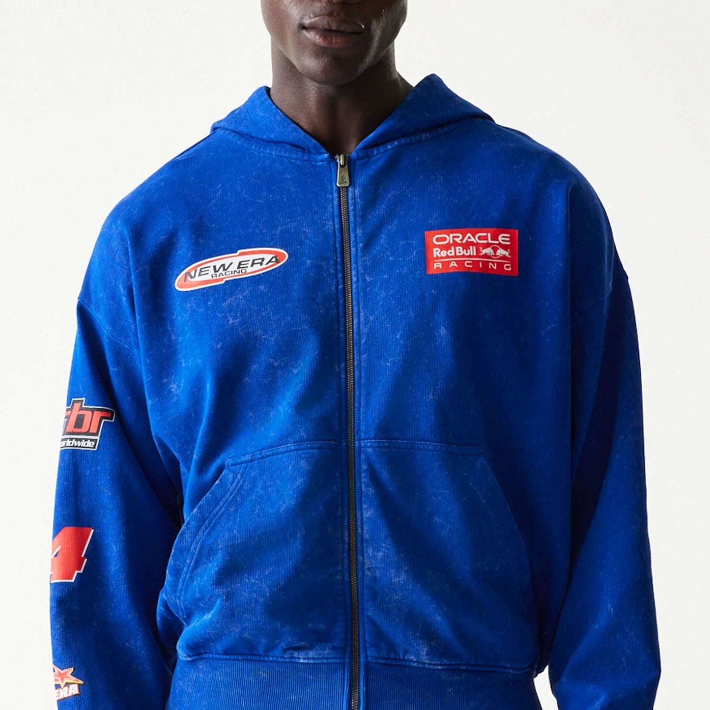 The model is wearing this Red Bull Racing Graphic Dropped Shoulder Full Zip Hoodie in blue. 3