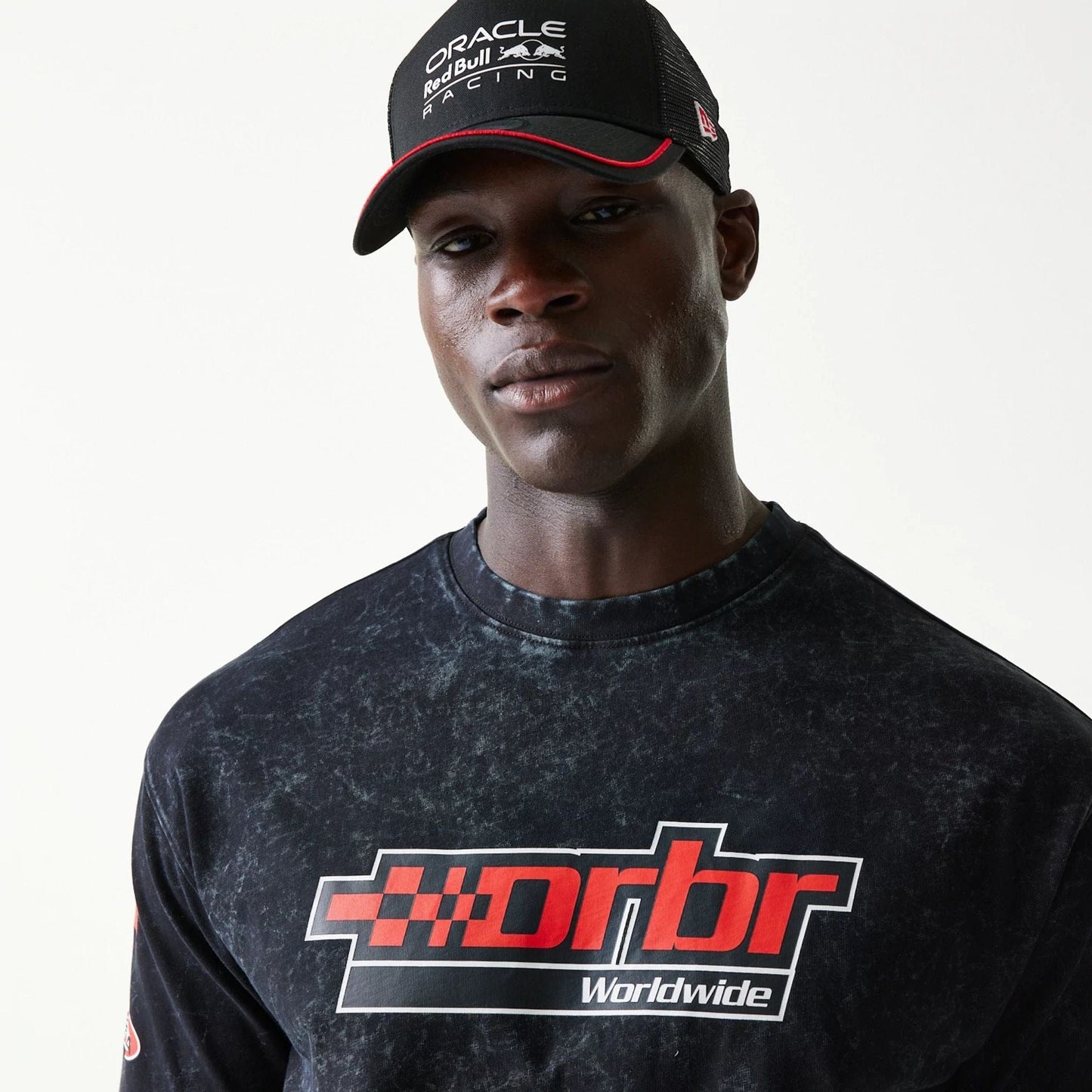 The model is wearing this Red Bull Racing Graphic Oversized T-Shirt in black. 4