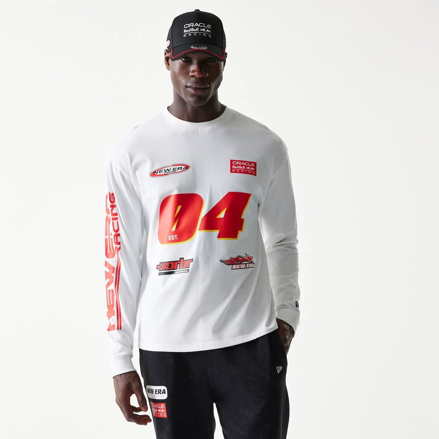 The model is wearing this Red Bull Racing Graphic Long Sleeve T-Shirt in white. 1