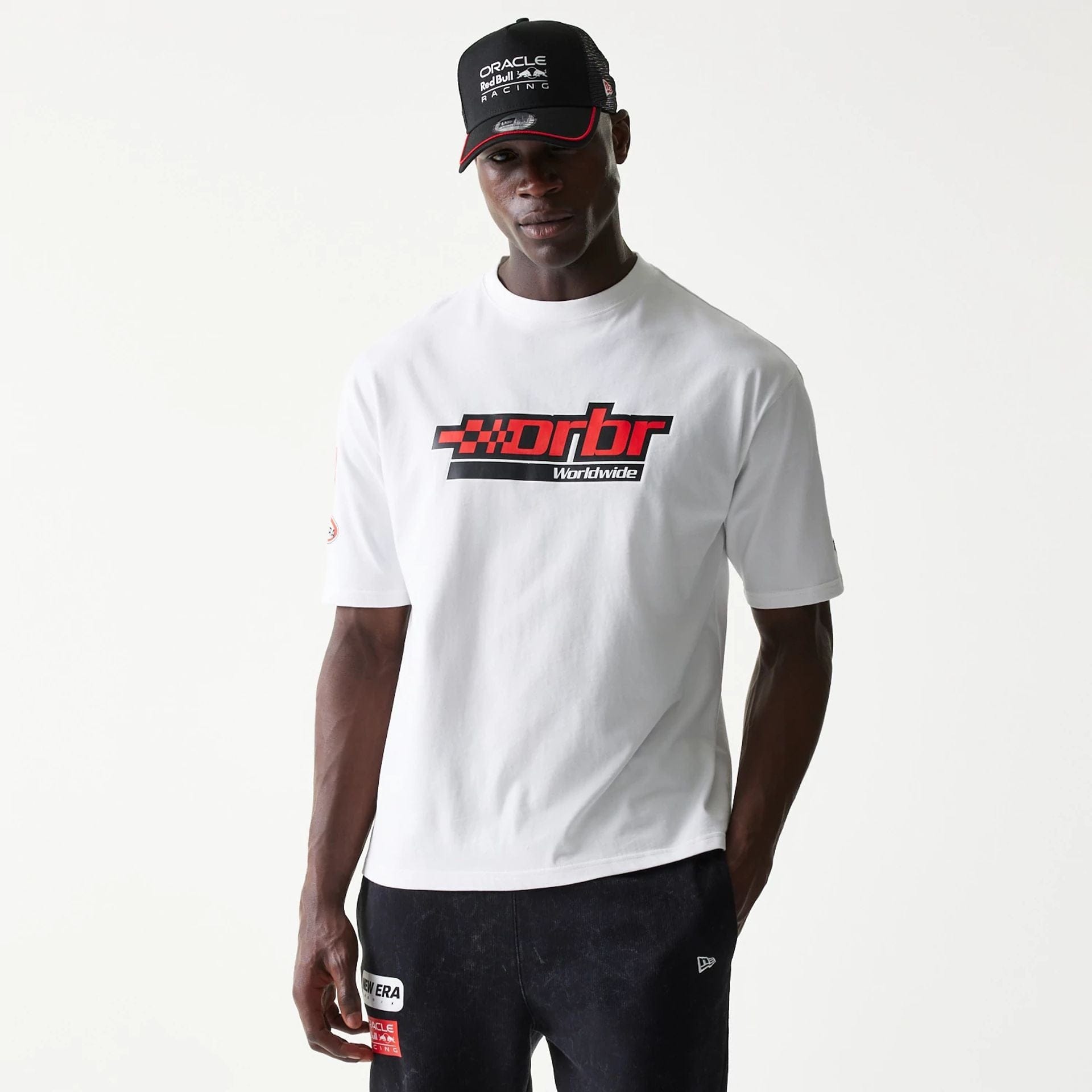 The model is wearing this Red Bull Racing Graphic Oversized T-Shirt in white. 1