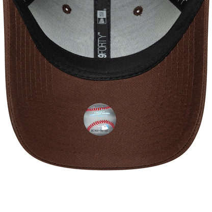 New York Yankees MLB Team Outline Brown New Era 9FORTY Cap, inside view showing the black sweatband, grey interior with multiple eyelets, and a baseball-themed MLB sticker on the brown curved visor.