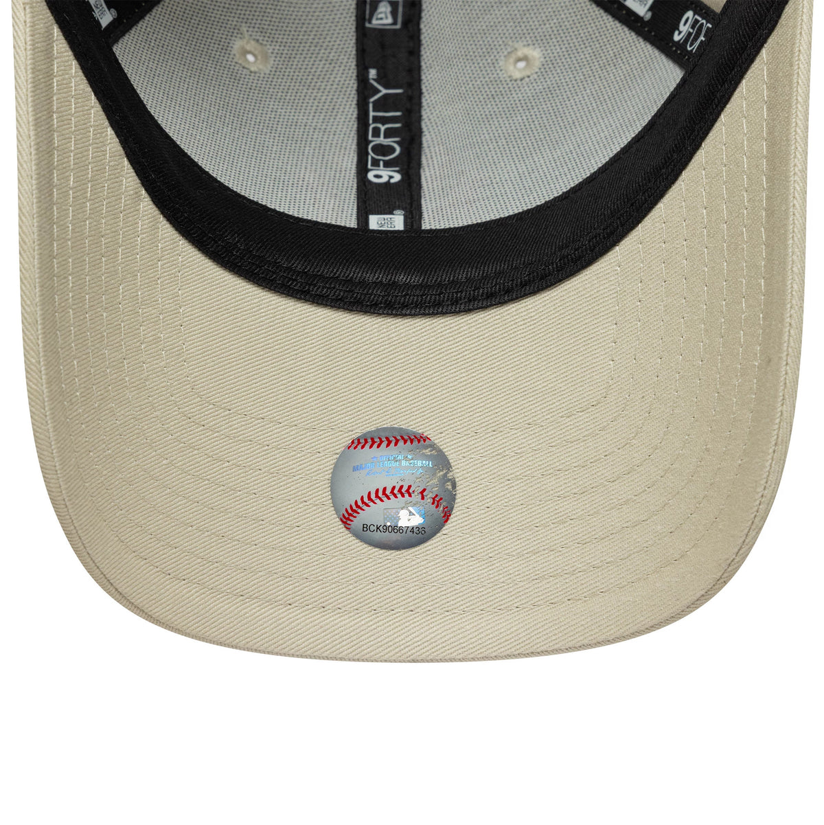 New York Yankees Womens MLB Light Beige New Era 9FORTY Cap, inside view showing black taping with white branding, a black sweatband, and a baseball-themed sticker on the light beige undervisor.
