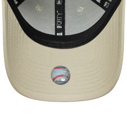 New York Yankees Womens MLB Light Beige New Era 9FORTY Cap, inside view showing black taping with white branding, a black sweatband, and a baseball-themed sticker on the light beige undervisor.