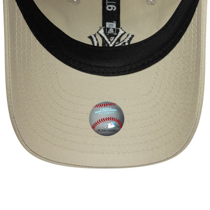 New York Yankees Youth MLB Light Beige New Era 9TWENTY Cap, inside view showing black taping with white branding, a black sweatband, the light beige undervisor, and the MLB holographic sticker placed centrally near the edge.