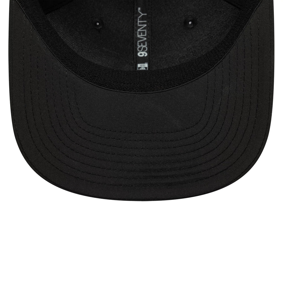 AC Milan Black New Era 9SEVENTY Stretch Snap Cap, inside view showing the glossy black undervisor with black inner taping featuring the 9SEVENTY text, set against the black fabric, the structural seams.
