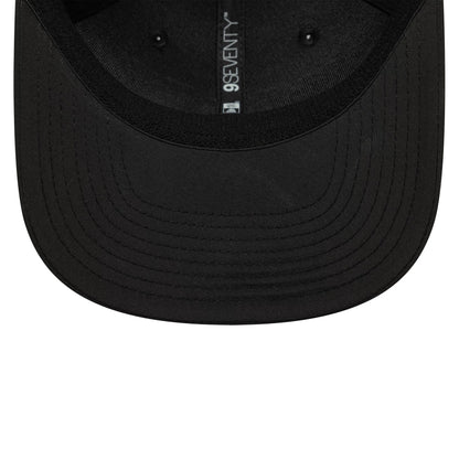 AC Milan Black New Era 9SEVENTY Stretch Snap Cap, inside view showing the glossy black undervisor with black inner taping featuring the 9SEVENTY text, set against the black fabric, the structural seams.