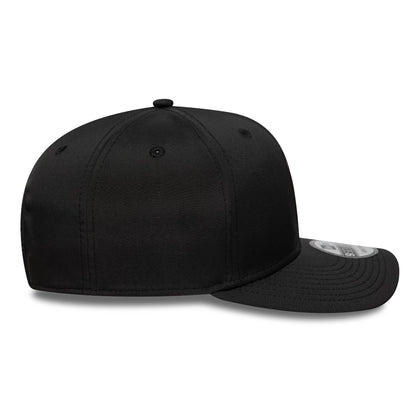 AC Milan Black New Era 9SEVENTY Stretch Snap Cap, side view showing the black crown and visor with a curved shape, small top button, embroidered eyelets, and a 9SEVENTY size sticker on the visor.
